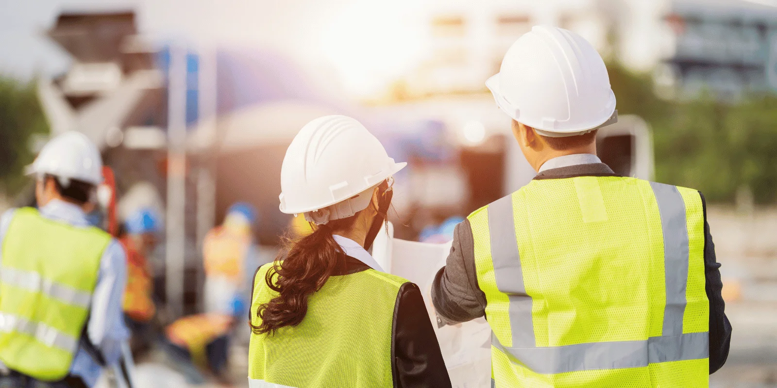 Site team in hi-vis reviewing work at sunrise